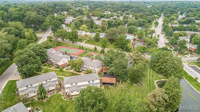 aerial view of residential area featuring a large body of water