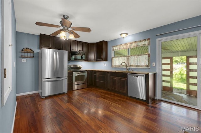 944 Millwood Dr, Saint Peters, MO 63376 - kitchen with appliances with stainless steel finishes, dark brown cabinets, a sink, ceiling fan, and dark wood-type flooring