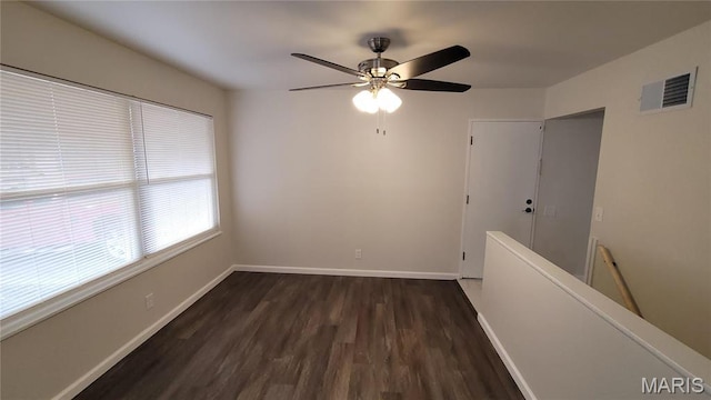 10216 Pannell Dr, Saint Louis, MO 63136 - empty room featuring dark wood-style flooring, a ceiling fan, and baseboards