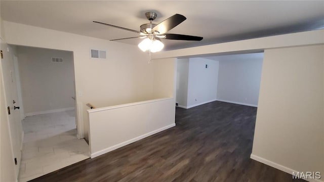 10216 Pannell Dr, Saint Louis, MO 63136 - empty room featuring a ceiling fan, baseboards, and dark wood-style floors
