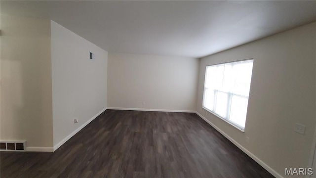 10216 Pannell Dr, Saint Louis, MO 63136 - spare room featuring dark wood finished floors and baseboards