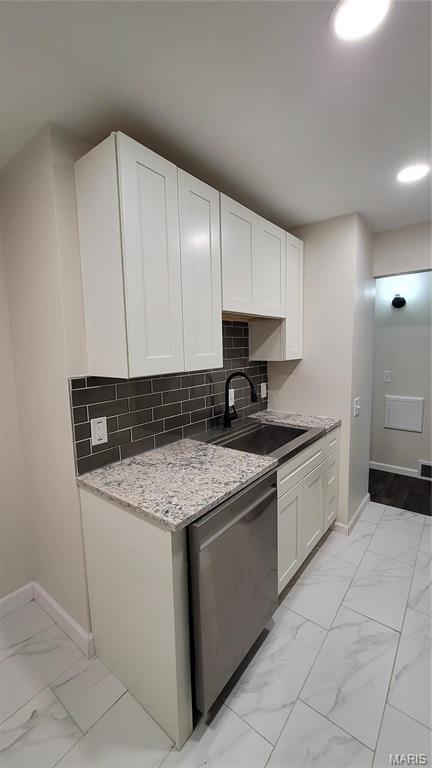 10216 Pannell Dr, Saint Louis, MO 63136 - kitchen featuring dishwasher, a sink, baseboards, and light marble finish flooring