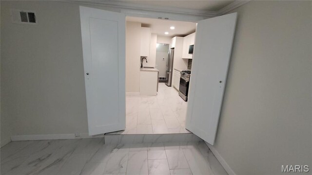 10216 Pannell Dr, Saint Louis, MO 63136 - hallway with light marble finish flooring, a sink, baseboards, recessed lighting, and crown molding