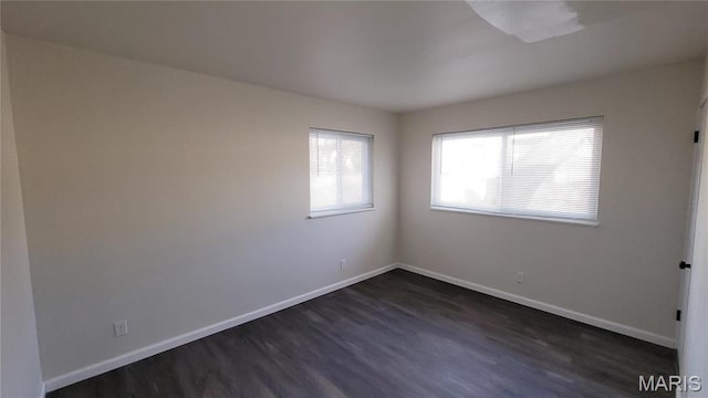 10216 Pannell Dr, Saint Louis, MO 63136 - spare room featuring dark wood-type flooring and baseboards