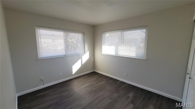 10216 Pannell Dr, Saint Louis, MO 63136 - empty room featuring dark wood-style flooring and baseboards