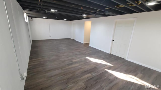 10216 Pannell Dr, Saint Louis, MO 63136 - finished below grade area featuring dark wood-style flooring and baseboards
