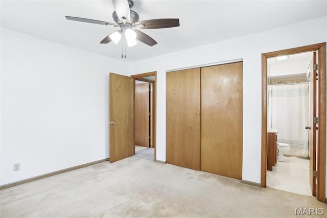 29 Zinnia Dr, Belleville, IL 62221 - unfurnished bedroom with light colored carpet, a closet, ensuite bath, baseboards, and ceiling fan