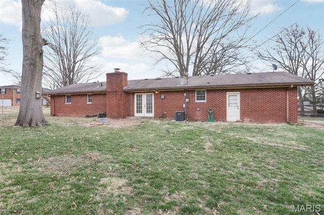 29 Zinnia Dr, Belleville, IL 62221 - rear view of property with french doors, brick siding, a lawn, and a chimney