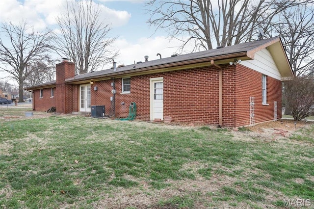 29 Zinnia Dr, Belleville, IL 62221 - back of property featuring a chimney, a yard, brick siding, and french doors