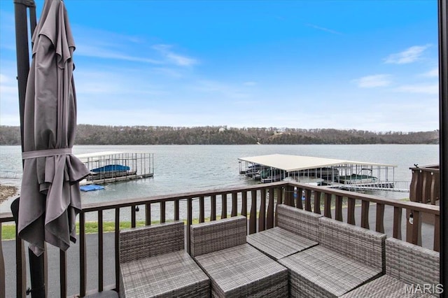 wooden terrace featuring a water view