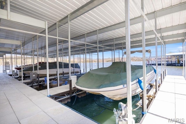 dock featuring boat lift and a water view