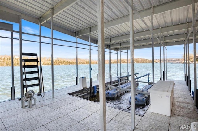 dock area with boat lift and a water view