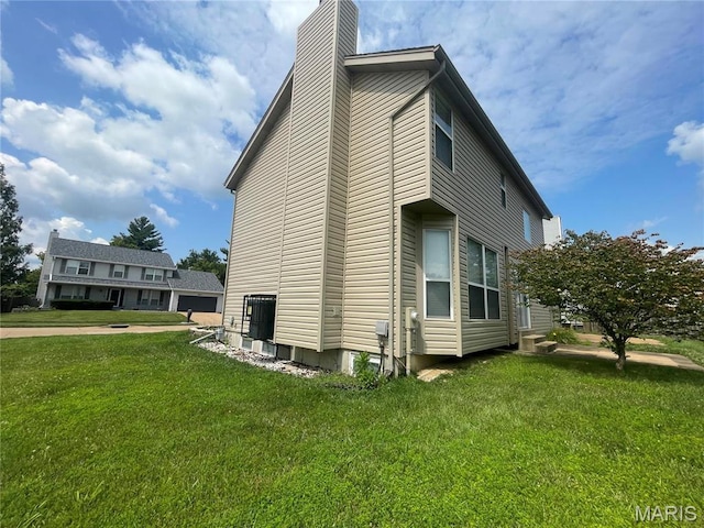3078 Willow Creek Estates Dr, Florissant, MO 63031 - view of property exterior with a chimney and a yard