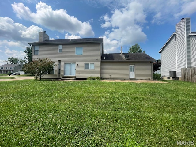 3078 Willow Creek Estates Dr, Florissant, MO 63031 - back of property featuring a chimney, a yard, and cooling unit
