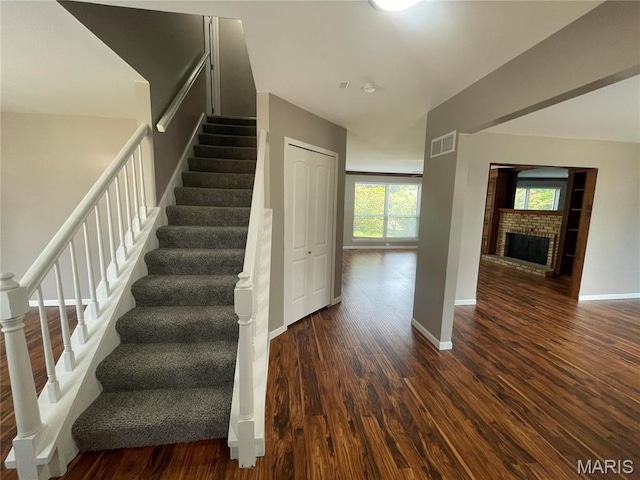 3078 Willow Creek Estates Dr, Florissant, MO 63031 - staircase featuring wood finished floors, baseboards, and a fireplace