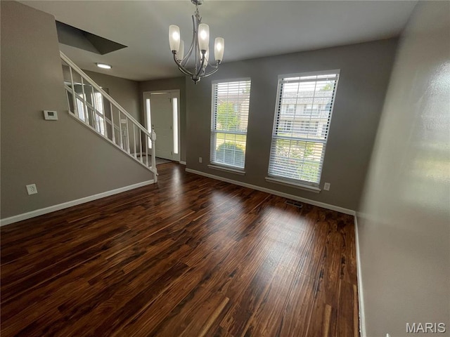 3078 Willow Creek Estates Dr, Florissant, MO 63031 - unfurnished dining area featuring dark wood-style floors, baseboards, stairway, and a chandelier