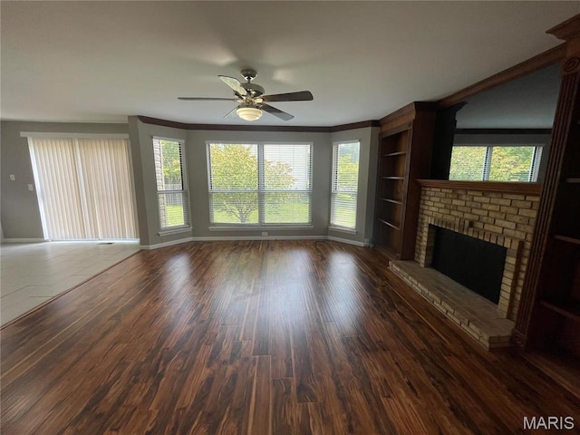 3078 Willow Creek Estates Dr, Florissant, MO 63031 - unfurnished living room featuring a fireplace, baseboards, ceiling fan, wood finished floors, and healthy amount of natural light
