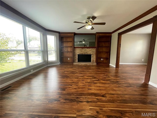 3078 Willow Creek Estates Dr, Florissant, MO 63031 - unfurnished living room featuring a ceiling fan, baseboards, crown molding, dark wood finished floors, and a fireplace