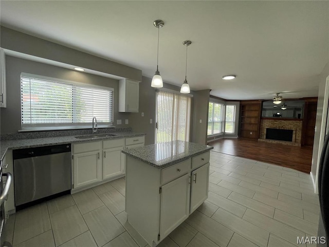 3078 Willow Creek Estates Dr, Florissant, MO 63031 - kitchen featuring dishwasher, a sink, a center island, and light tile patterned floors