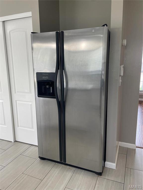3078 Willow Creek Estates Dr, Florissant, MO 63031 - detailed view of stainless steel fridge with ice dispenser and wood finish floors