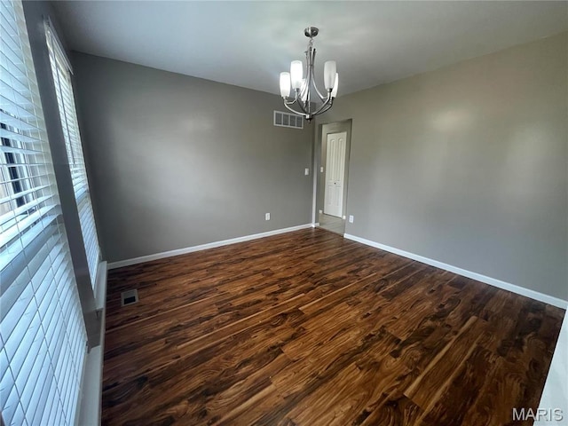 3078 Willow Creek Estates Dr, Florissant, MO 63031 - unfurnished room featuring a chandelier, dark wood-style floors, and baseboards