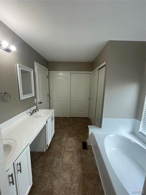 3078 Willow Creek Estates Dr, Florissant, MO 63031 - full bath with double vanity and a bath