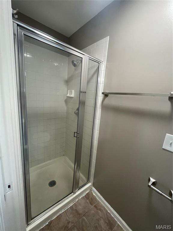 3078 Willow Creek Estates Dr, Florissant, MO 63031 - bathroom featuring a shower stall, baseboards, and tile patterned floors