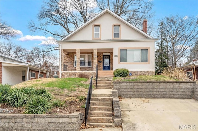 7415 Wellington Ave, Saint Louis, MO 63130 - view of front of house featuring covered porch, stucco siding, a chimney, and stone siding