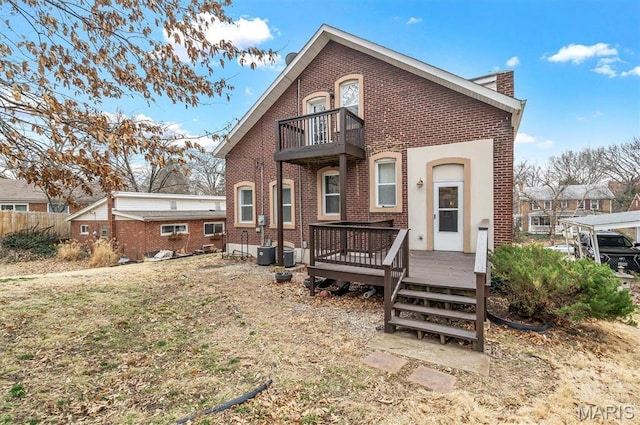 7415 Wellington Ave, Saint Louis, MO 63130 - back of property featuring a balcony, brick siding, and a deck