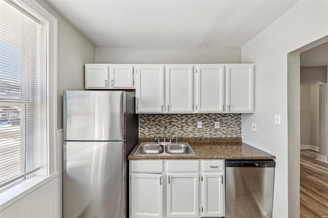 7001 Plymouth Ave, Saint Louis, MO 63130 - kitchen featuring appliances with stainless steel finishes, a sink, dark countertops, and plenty of natural light