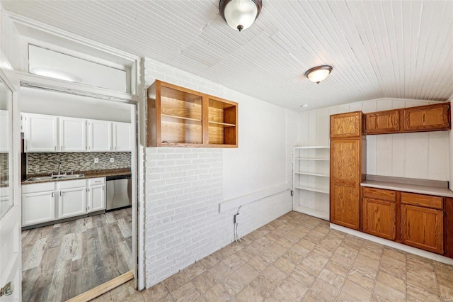 7001 Plymouth Ave, Saint Louis, MO 63130 - kitchen with a sink, stainless steel dishwasher, open shelves, vaulted ceiling, and decorative backsplash