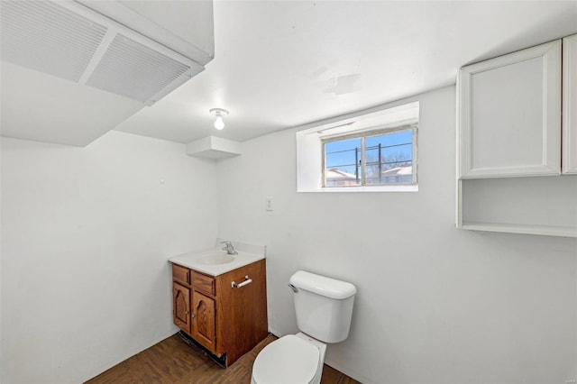 7001 Plymouth Ave, Saint Louis, MO 63130 - half bath featuring toilet, wood finished floors, and vanity