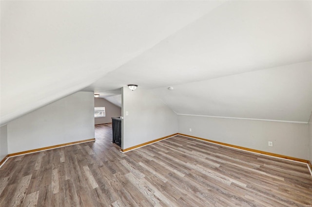 7001 Plymouth Ave, Saint Louis, MO 63130 - additional living space with lofted ceiling, baseboards, and wood finished floors