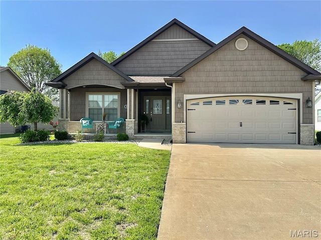 1421 Winchester Grove Ct, Ofallon, IL 62269 - view of front of house with a porch, an attached garage, concrete driveway, a front lawn, and stone siding