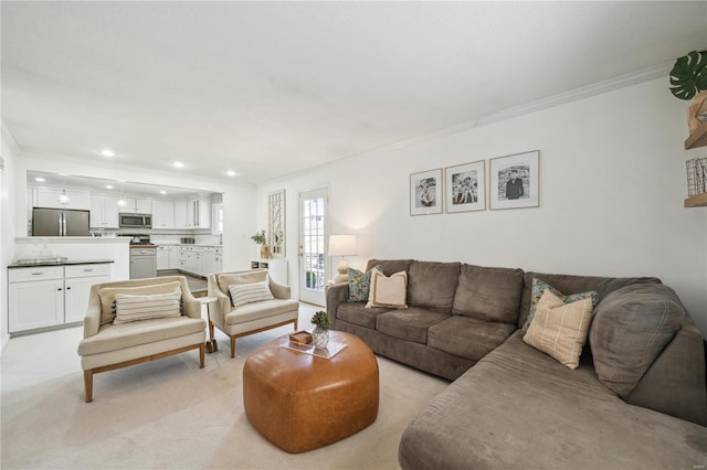 living room featuring ornamental molding, recessed lighting, and light carpet