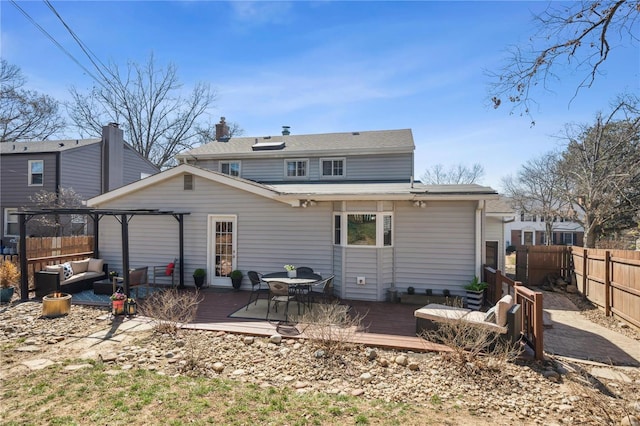 rear view of house with an outdoor hangout area, a wooden deck, and a fenced backyard