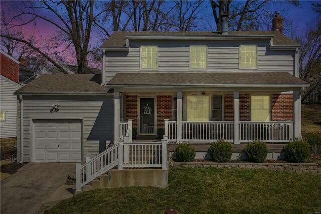 view of front facade featuring covered porch, a garage, a chimney, driveway, and brick siding