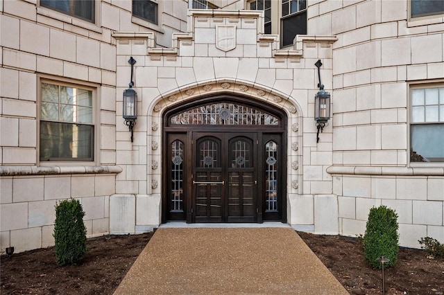 property entrance featuring stone siding