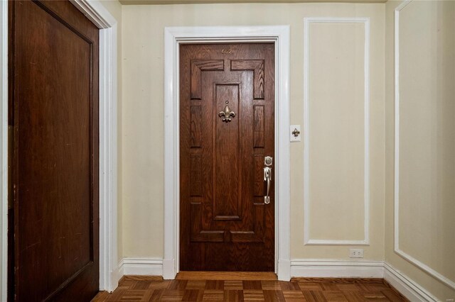 doorway to outside featuring baseboards