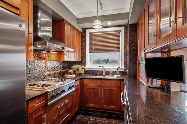 kitchen featuring wall chimney range hood, appliances with stainless steel finishes, ornamental molding, a sink, and granite tiled floors