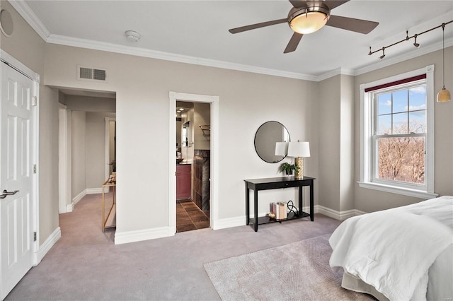 bedroom featuring carpet flooring, rail lighting, ornamental molding, and baseboards
