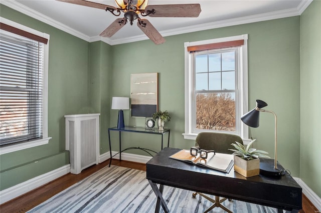 home office featuring plenty of natural light, wood finished floors, baseboards, and crown molding