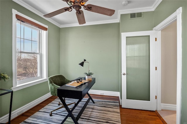 office area with wood finished floors, healthy amount of natural light, baseboards, and crown molding