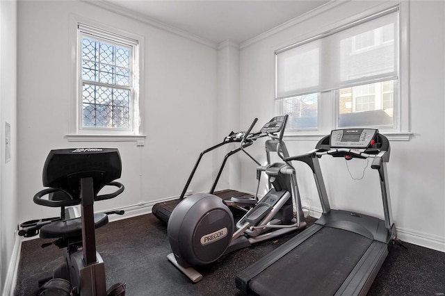 exercise room featuring healthy amount of natural light, baseboards, and ornamental molding