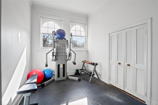 workout room with crown molding and baseboards