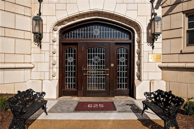 entrance to property featuring french doors and stone siding