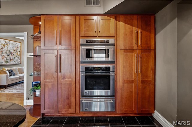 625 S Skinker Blvd Unit 602, Saint Louis, MO 63105 - kitchen featuring a warming drawer, brown cabinets, and double oven