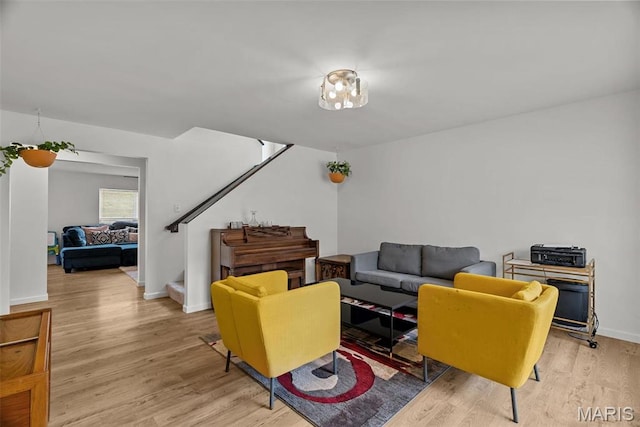 757 Fox Creek Dr, Fenton, MO 63026 - living room featuring stairway, light wood-style flooring, and baseboards