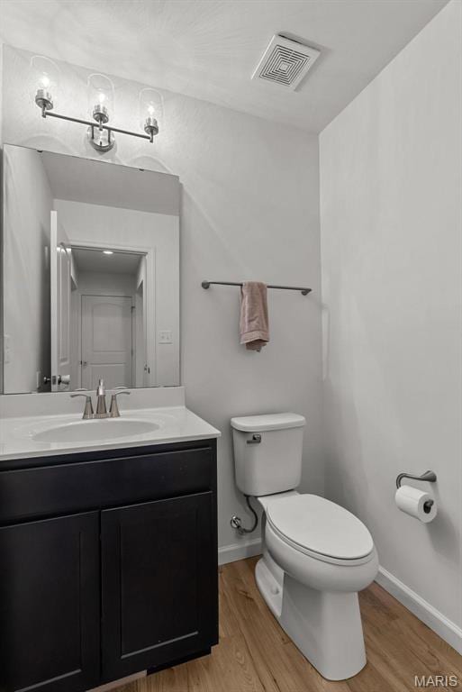 757 Fox Creek Dr, Fenton, MO 63026 - bathroom featuring toilet, wood finished floors, vanity, and baseboards