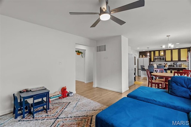 757 Fox Creek Dr, Fenton, MO 63026 - living area with a chandelier, light wood-type flooring, a ceiling fan, baseboards, and recessed lighting